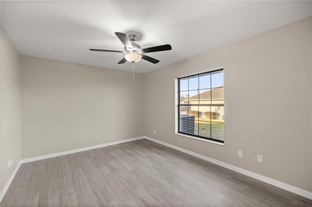 spare room with light hardwood / wood-style floors and ceiling fan