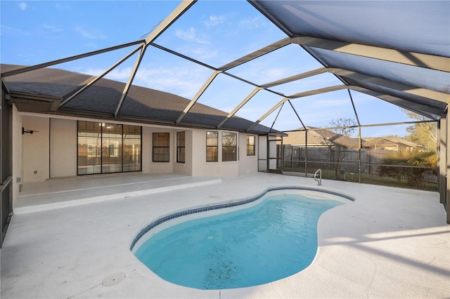 view of swimming pool featuring a patio and a lanai