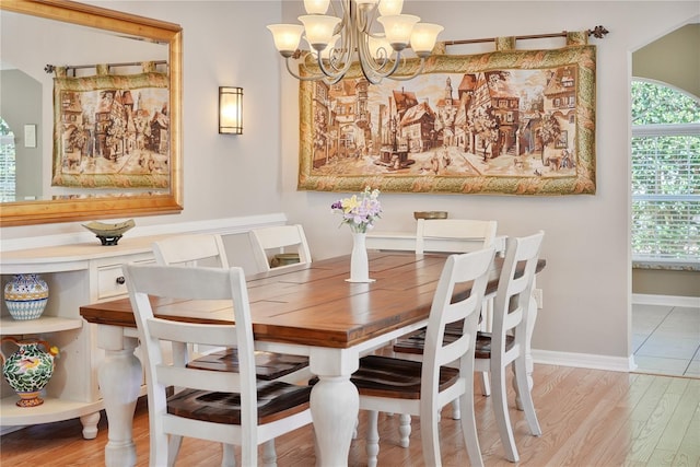 dining space featuring an inviting chandelier and light hardwood / wood-style floors