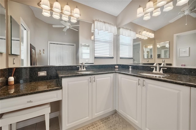 bathroom with lofted ceiling, vanity, and ceiling fan