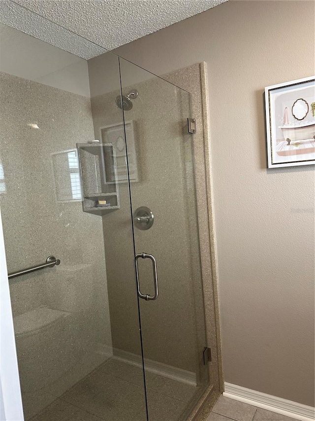 bathroom featuring an enclosed shower and tile patterned floors