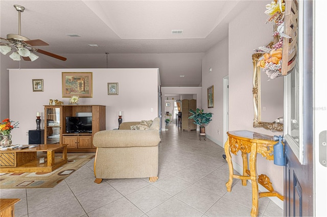 tiled living room featuring ceiling fan