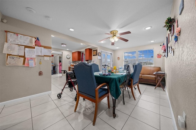 dining room with ceiling fan and light tile patterned flooring