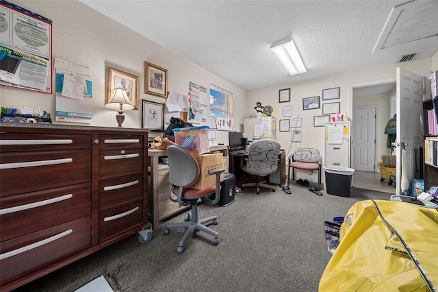 home office featuring carpet floors and a textured ceiling