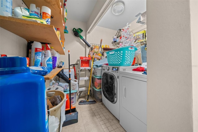 washroom with washer and clothes dryer and light tile patterned floors