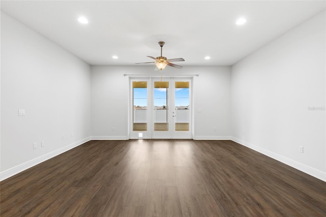 spare room with ceiling fan and dark wood-type flooring