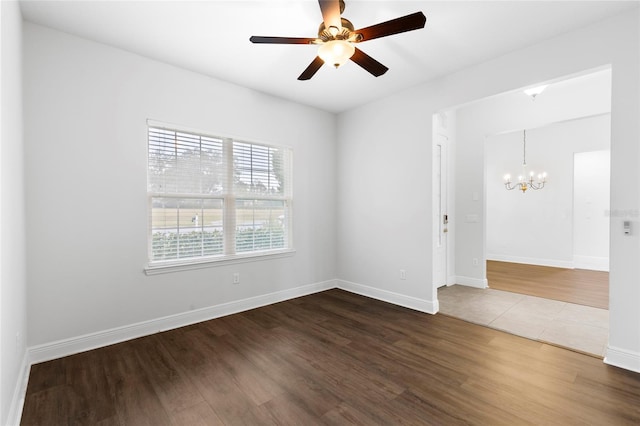 empty room featuring hardwood / wood-style floors and ceiling fan with notable chandelier