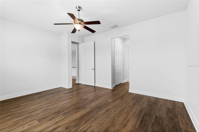 unfurnished bedroom with ceiling fan and dark wood-type flooring