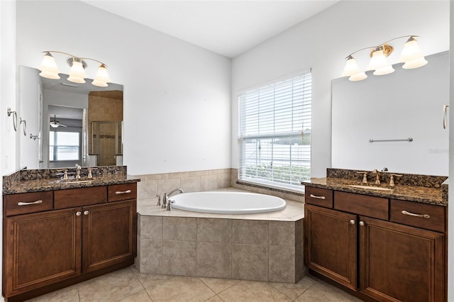 bathroom with tile patterned flooring, vanity, and a healthy amount of sunlight