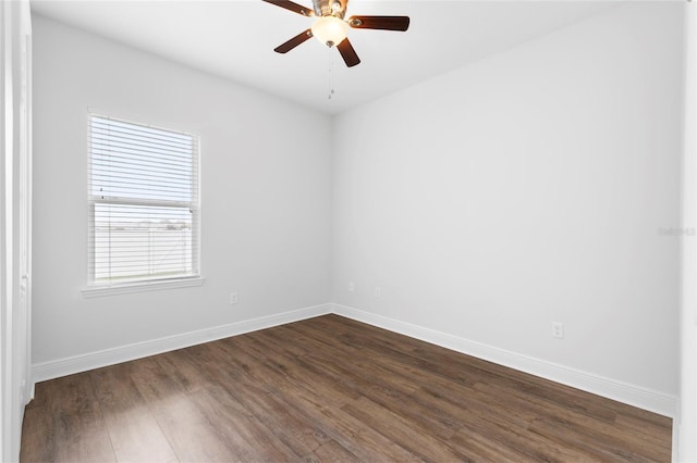 empty room with ceiling fan and dark wood-type flooring