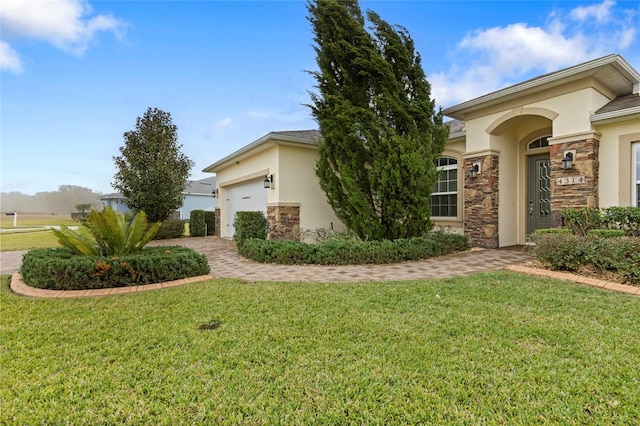 view of front of property with a front lawn and a garage