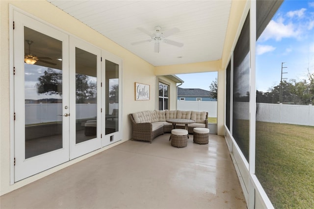 sunroom featuring ceiling fan and french doors