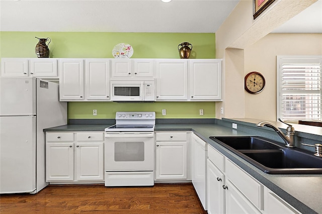 kitchen featuring white cabinets, dark hardwood / wood-style flooring, white appliances, and sink