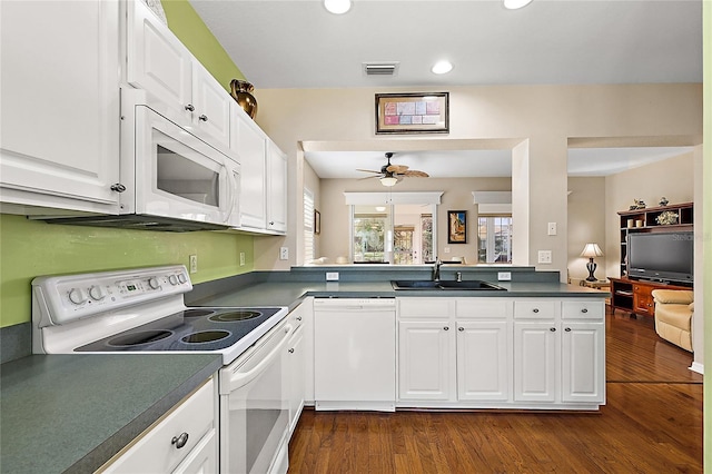 kitchen with white appliances, sink, kitchen peninsula, ceiling fan, and white cabinetry