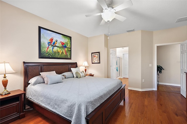 bedroom with dark hardwood / wood-style flooring and ceiling fan