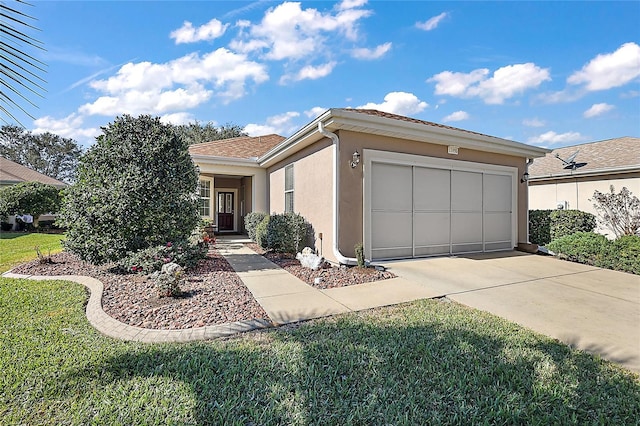 view of front of home with a front lawn and a garage