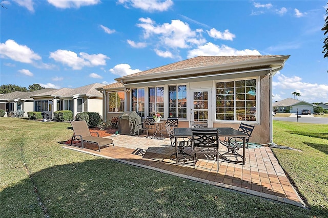 rear view of house with a yard and a patio