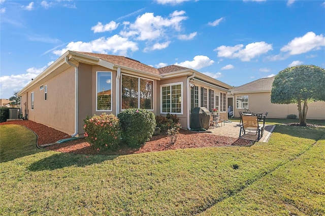 rear view of property with central air condition unit, a yard, and a patio