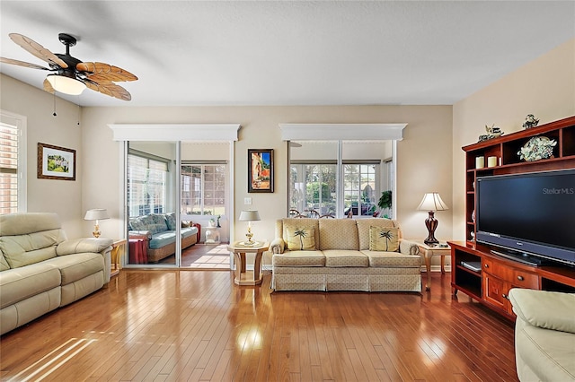 living room featuring ceiling fan and hardwood / wood-style floors