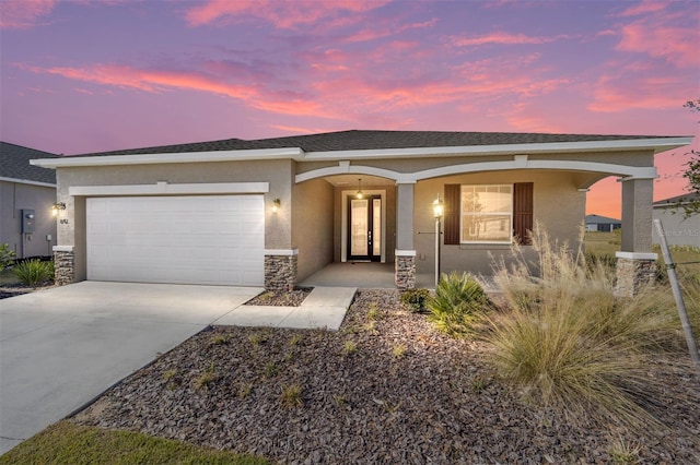 single story home featuring a garage and covered porch