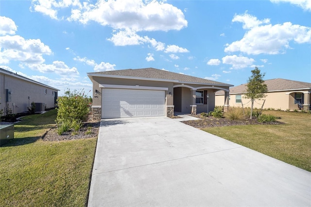 view of front of home with central air condition unit, a front lawn, and a garage