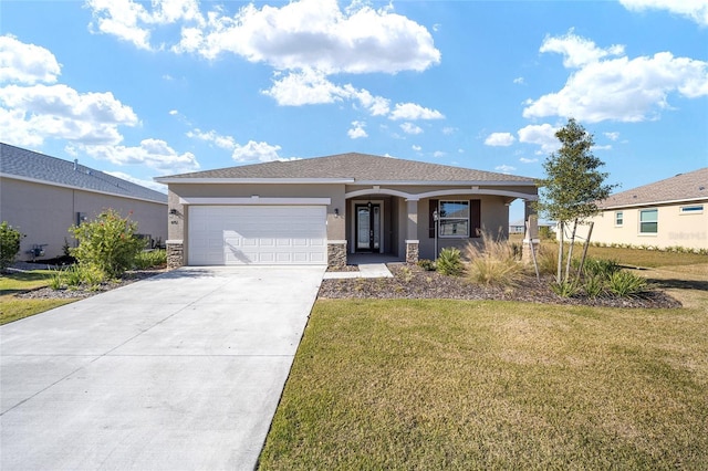 view of front of home with a garage and a front lawn