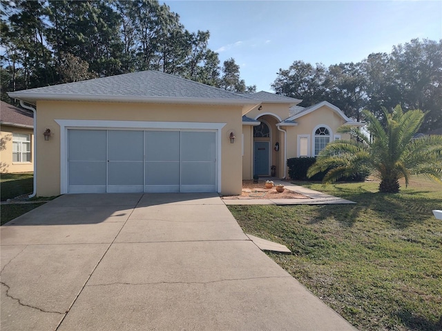 ranch-style house featuring a garage and a front lawn