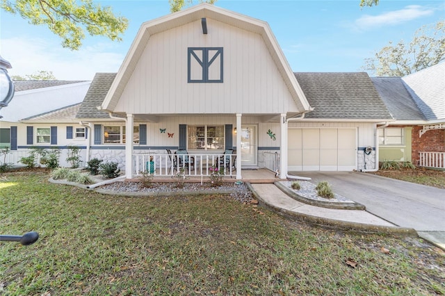 view of front facade with a front lawn, covered porch, and a garage