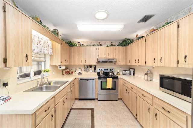 kitchen featuring light brown cabinets, sink, a textured ceiling, and appliances with stainless steel finishes