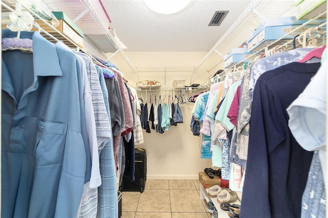 walk in closet with light tile patterned flooring