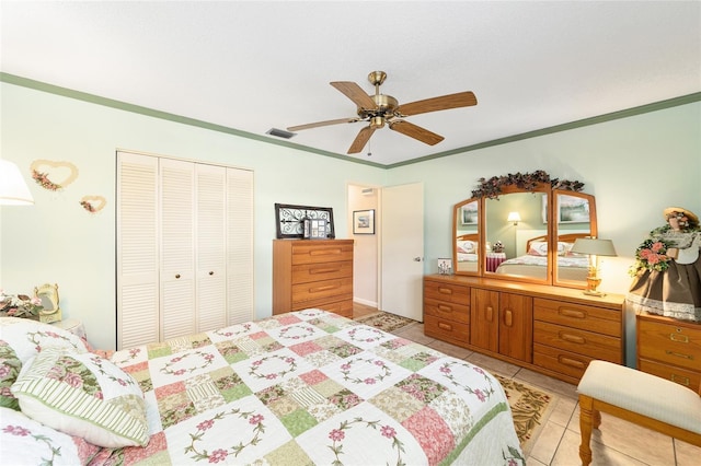 tiled bedroom featuring a closet, crown molding, and ceiling fan