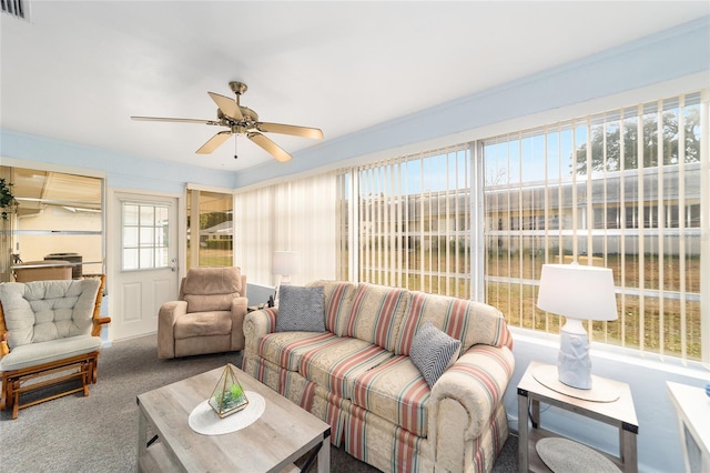 carpeted living room with ceiling fan