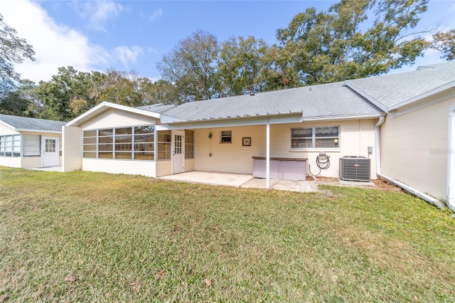 rear view of property with central AC, a sunroom, a yard, and a patio