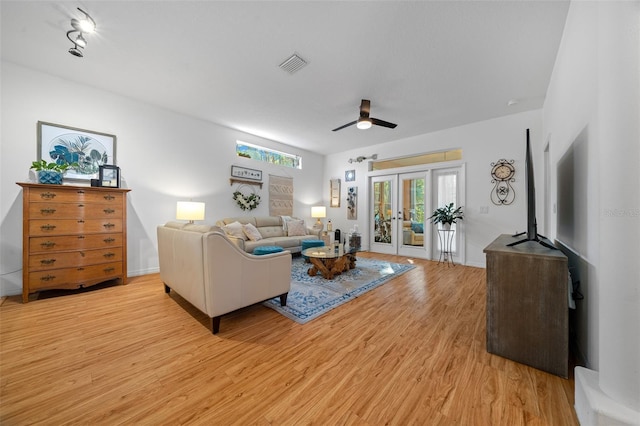 living room featuring ceiling fan, french doors, and light hardwood / wood-style floors