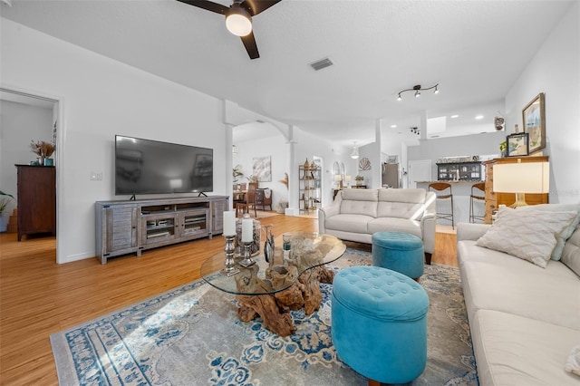 living room featuring ceiling fan and hardwood / wood-style floors