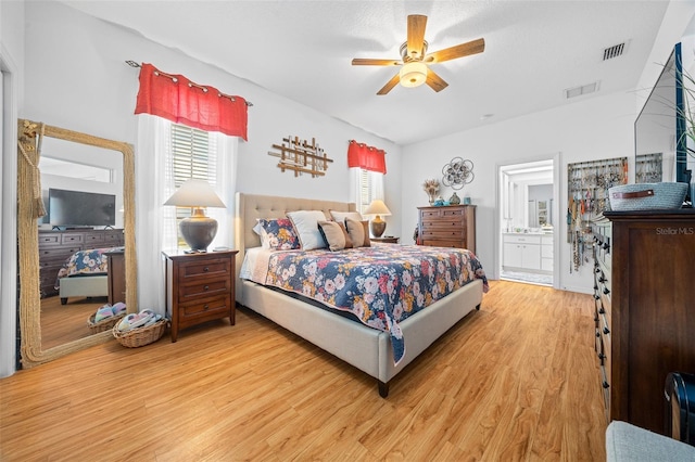 bedroom with ceiling fan, light hardwood / wood-style flooring, and ensuite bath