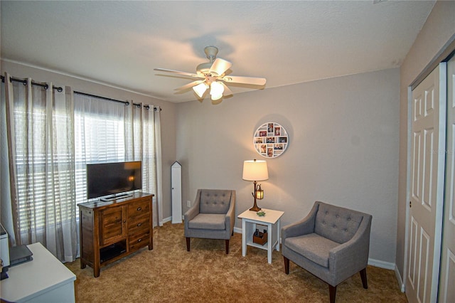 sitting room featuring carpet floors and ceiling fan