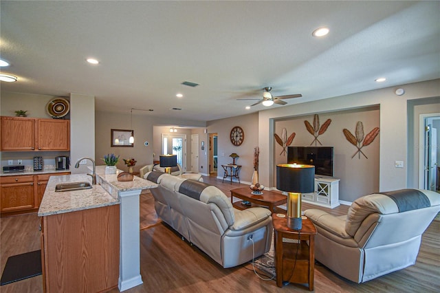 living room featuring a textured ceiling, dark hardwood / wood-style floors, ceiling fan, and sink