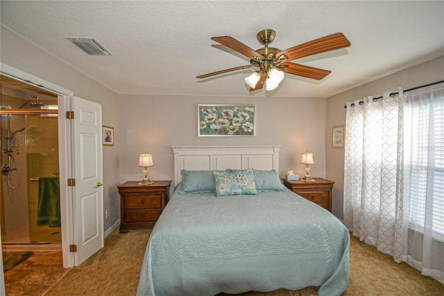 bedroom featuring ceiling fan, carpet, and a textured ceiling