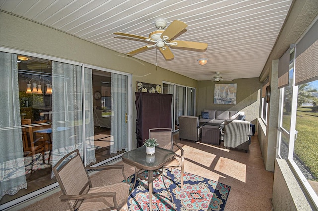 sunroom featuring ceiling fan