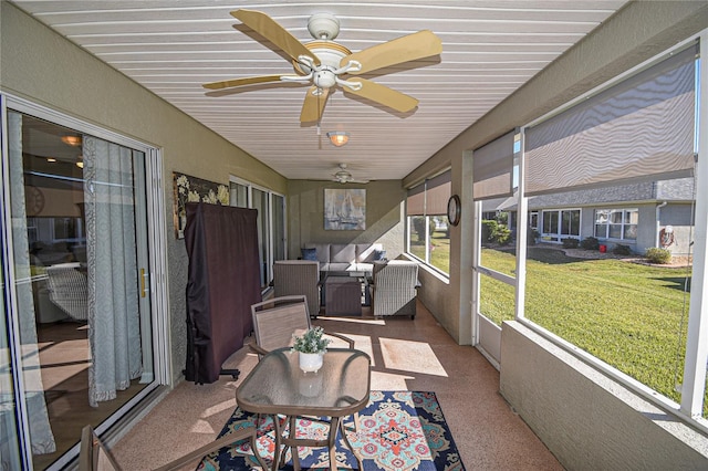 sunroom / solarium featuring ceiling fan