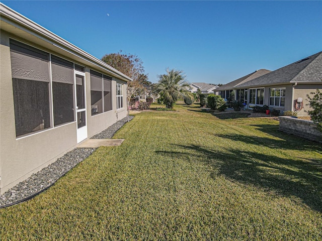 view of yard featuring a sunroom