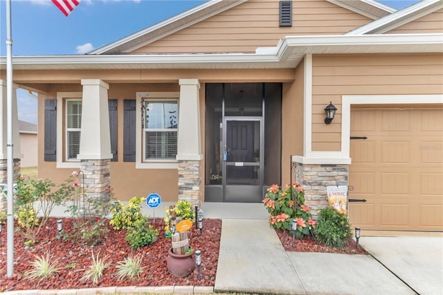 property entrance featuring a garage and a porch