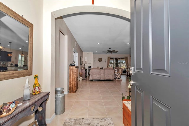 tiled entryway featuring ceiling fan