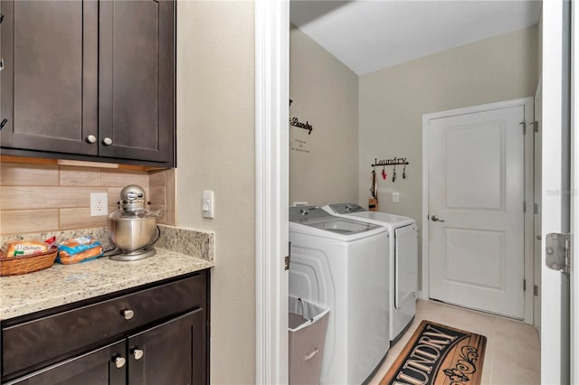 laundry room with independent washer and dryer, cabinets, and light tile patterned floors