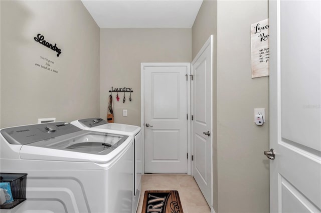 washroom with separate washer and dryer and light tile patterned floors