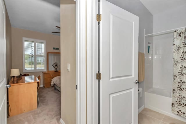 bathroom with tile patterned flooring, shower / bath combo, and ceiling fan