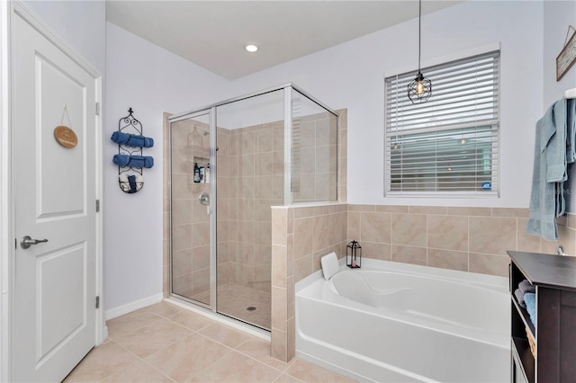 bathroom with tile patterned floors and independent shower and bath