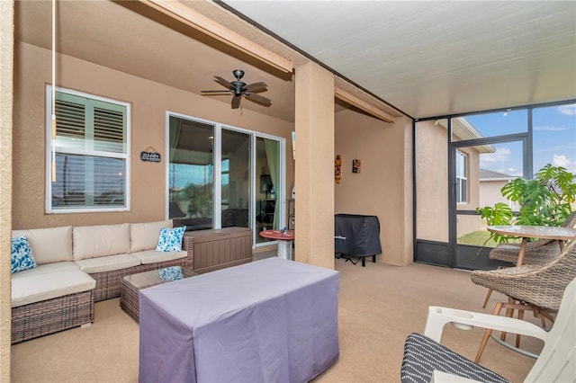 sunroom / solarium featuring ceiling fan