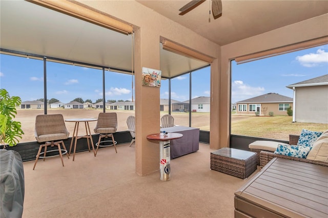 sunroom / solarium featuring ceiling fan